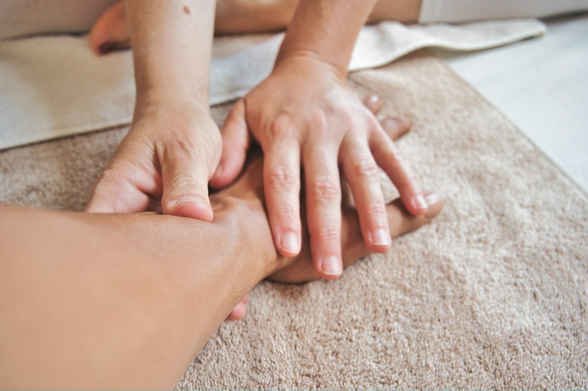 A pair of hands resting gently over another person's hand