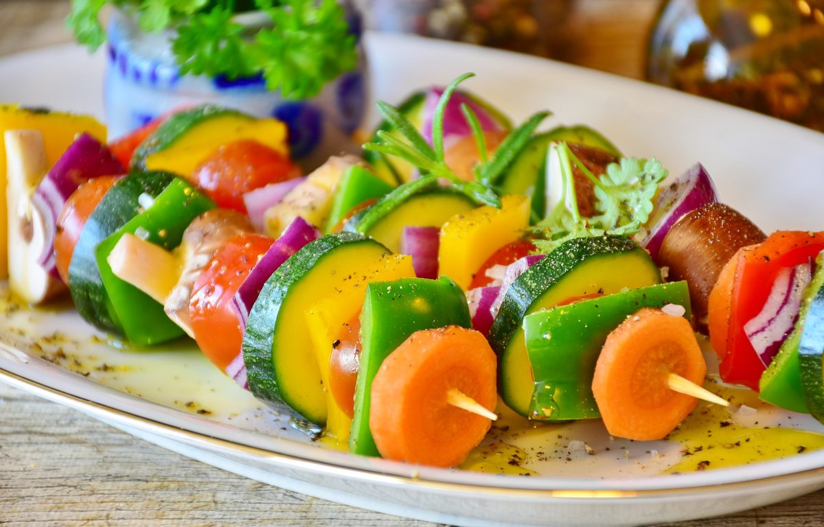 Colorful grilled vegetable skewers plated for a culinary medicine class